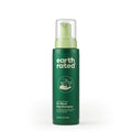 Green bottle of Earth Rated no-rinse dog shampoo on a white background